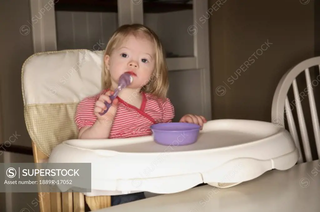 Girl in a high chair