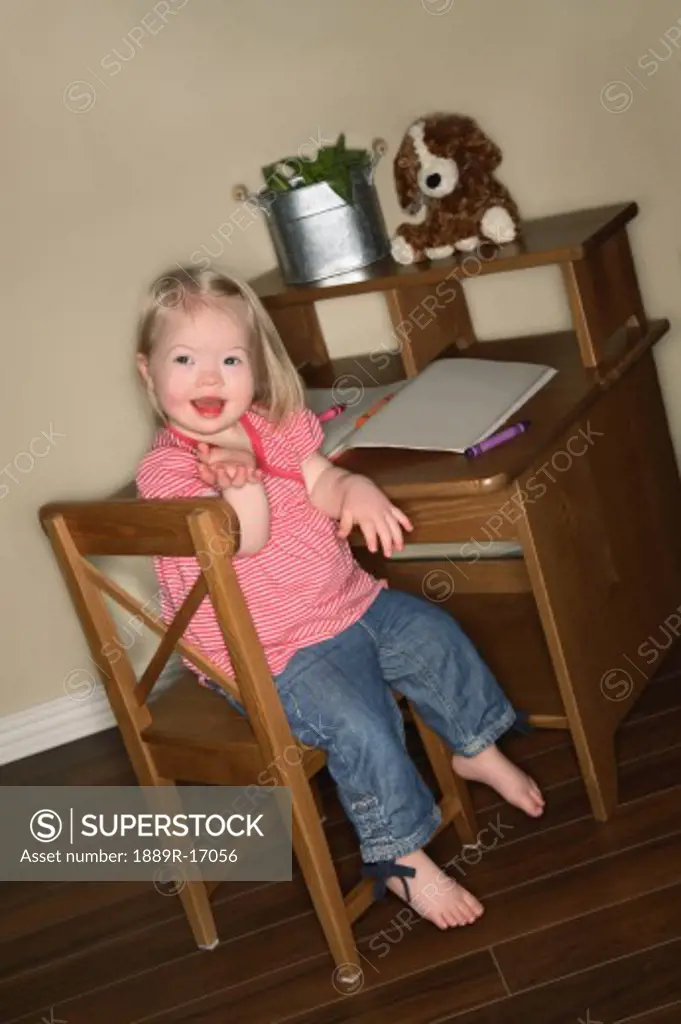 Young girl sitting at her desk