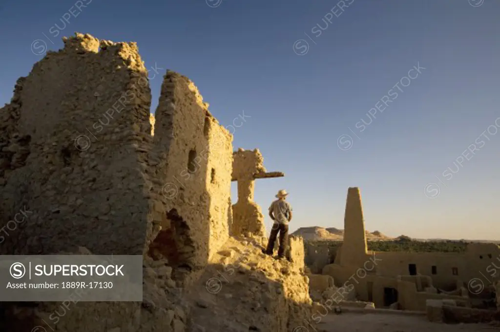 Siwa Oasis, Egypt; Man wearing a hat at the Temple of the Oracle of Amun