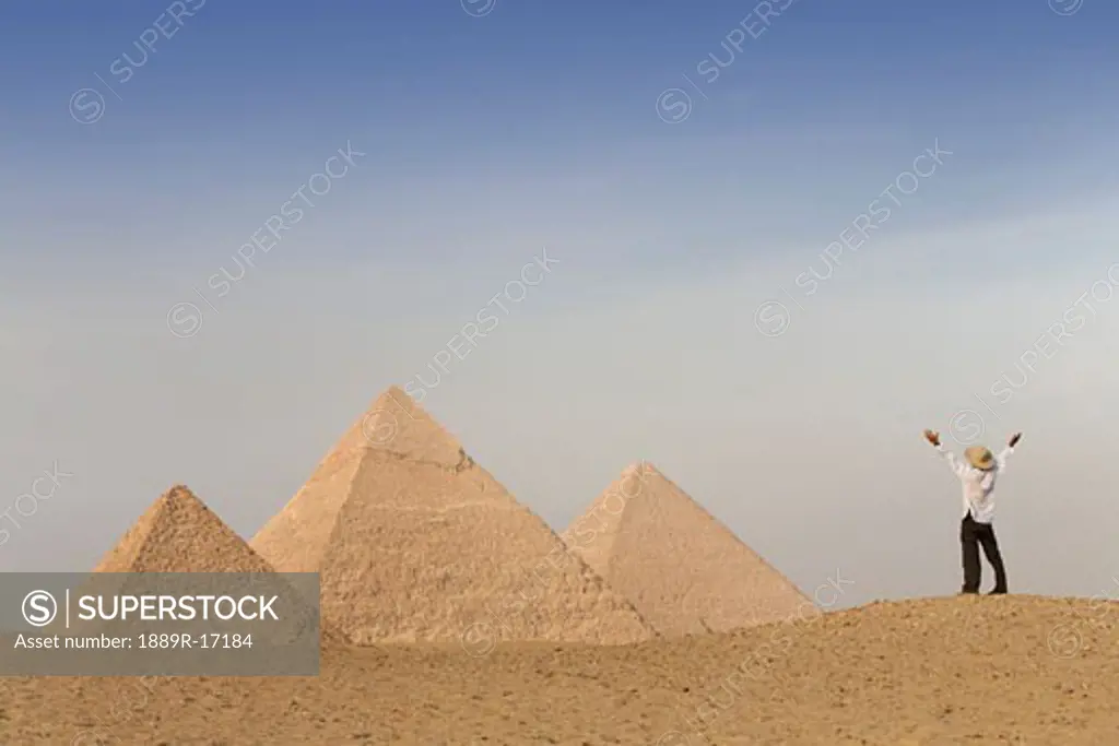 Cairo, Giza, Egypt; Tourist rejoicing at the Pyramids of Giza