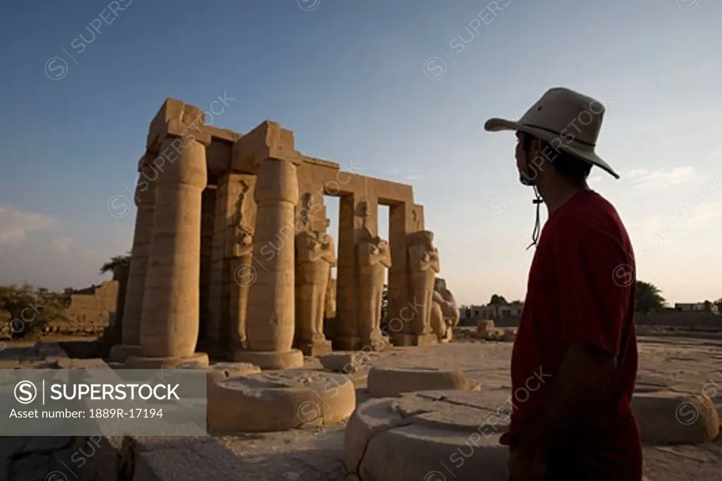 Luxor, Egypt; A tourist enjoying the view of the Ramesseum