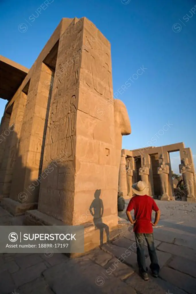 Luxor, Egypt; The Ramesseum, A tourist enjoying the view