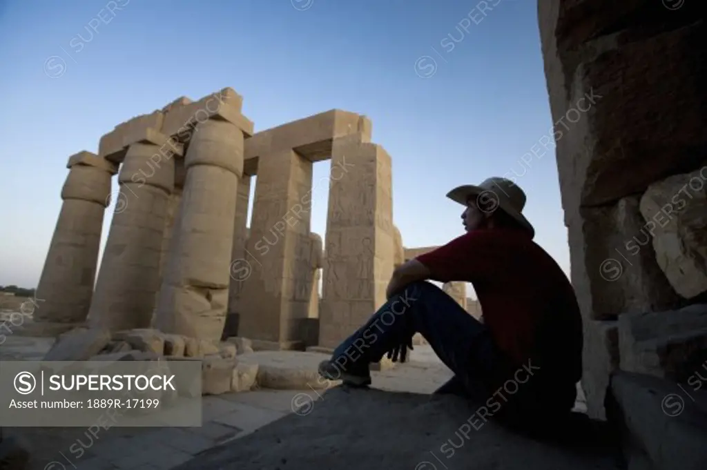 Luxor, Egypt; Man with hat visiting the Ramesseum