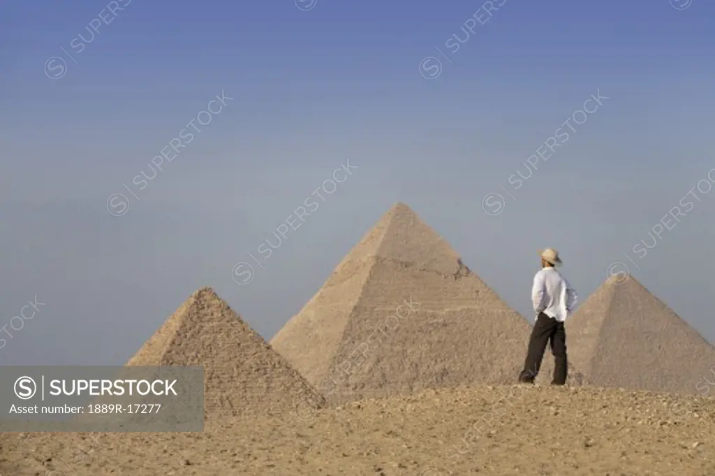 Pyramids of Giza, Cairo, Egypt; tourist looks out towards the pyramids