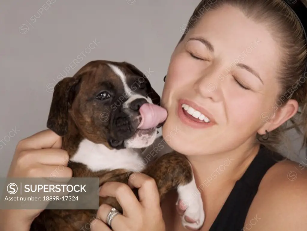 Affectionate dog; Woman holding a puppy