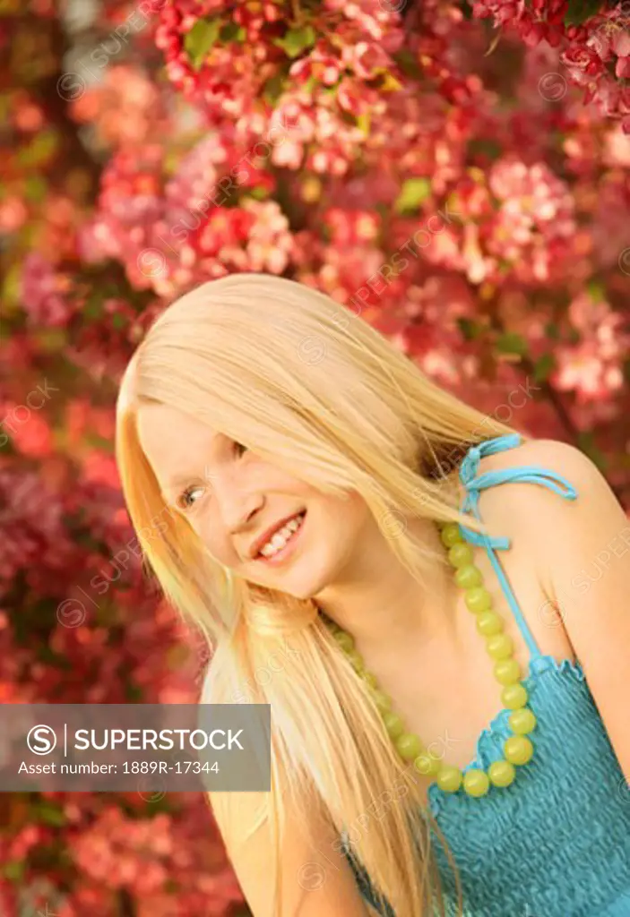 Portrait in spring; Pretty blonde girl outdoors