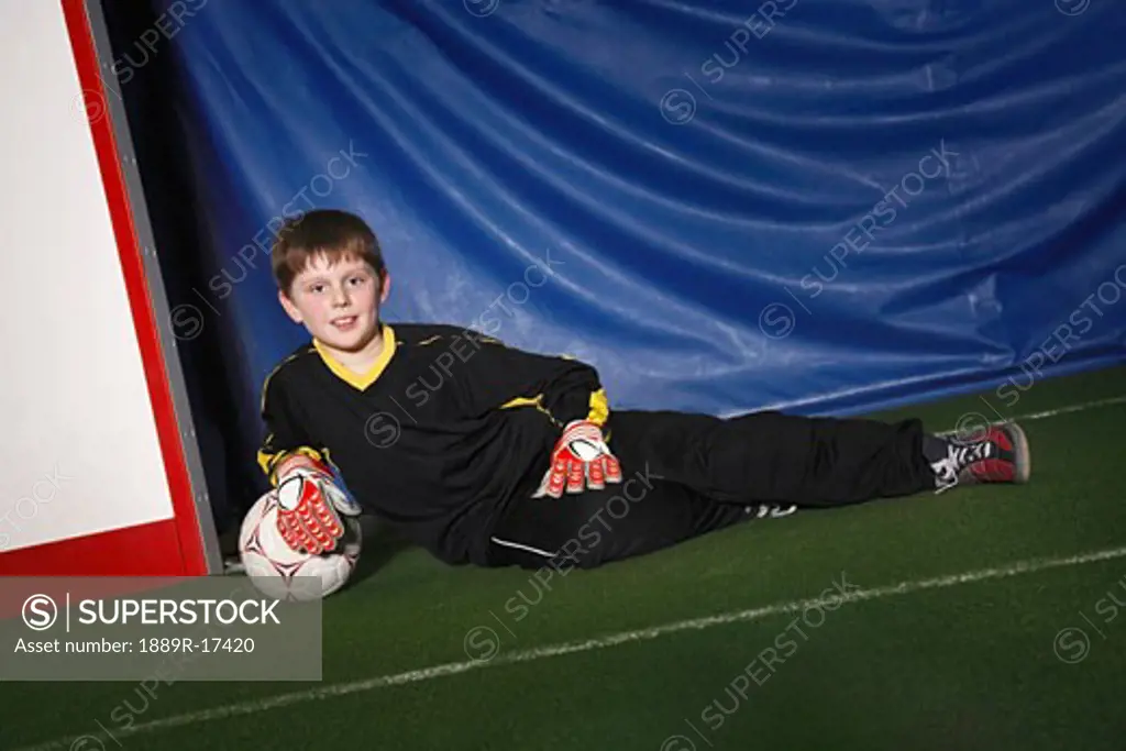 Boy in soccer net