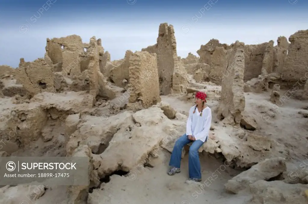 Siwa Town, Siwa Oasis, Egypt, Africa; Tourist enjoys mud brick fortress of Shali