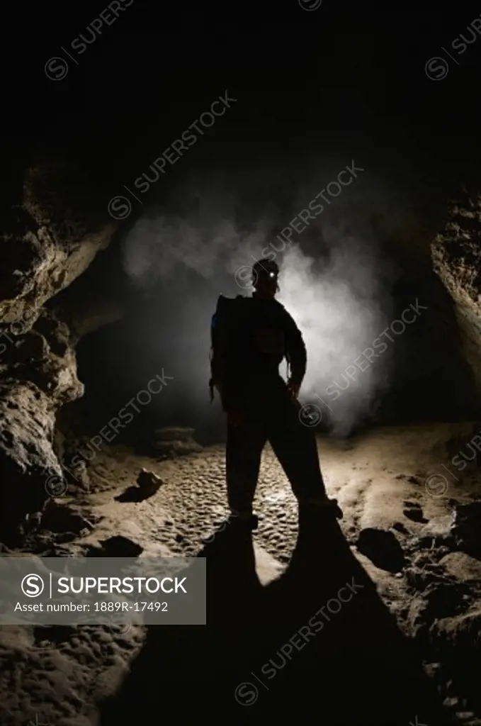 Man in a cave; spelunking