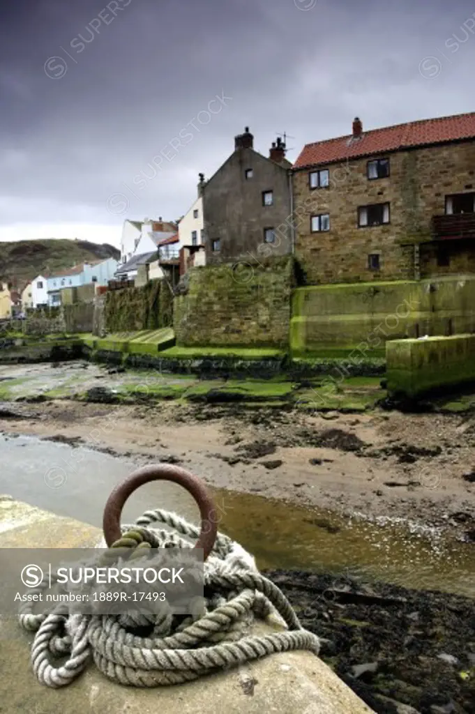 Staithes, Yorkshire, England; Rope tied to pier by beach