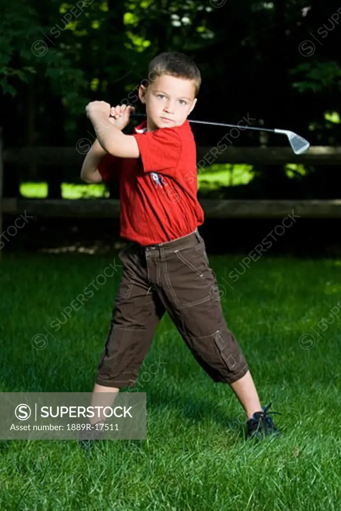 Little golfer; Young boy with a golf club