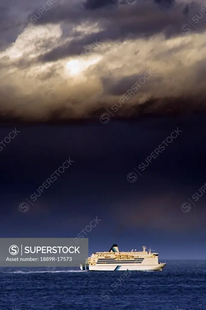 Transportation; Cruise ship under a dark cloud