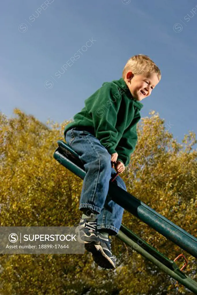 Upward; Boy having fun on a seesaw