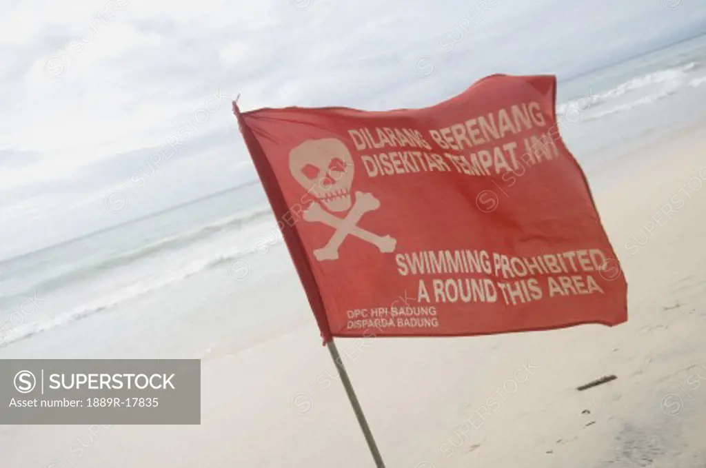Pecatu Village, Nusa Dua, Bali, Indonesia; Warning flag on Bali beach