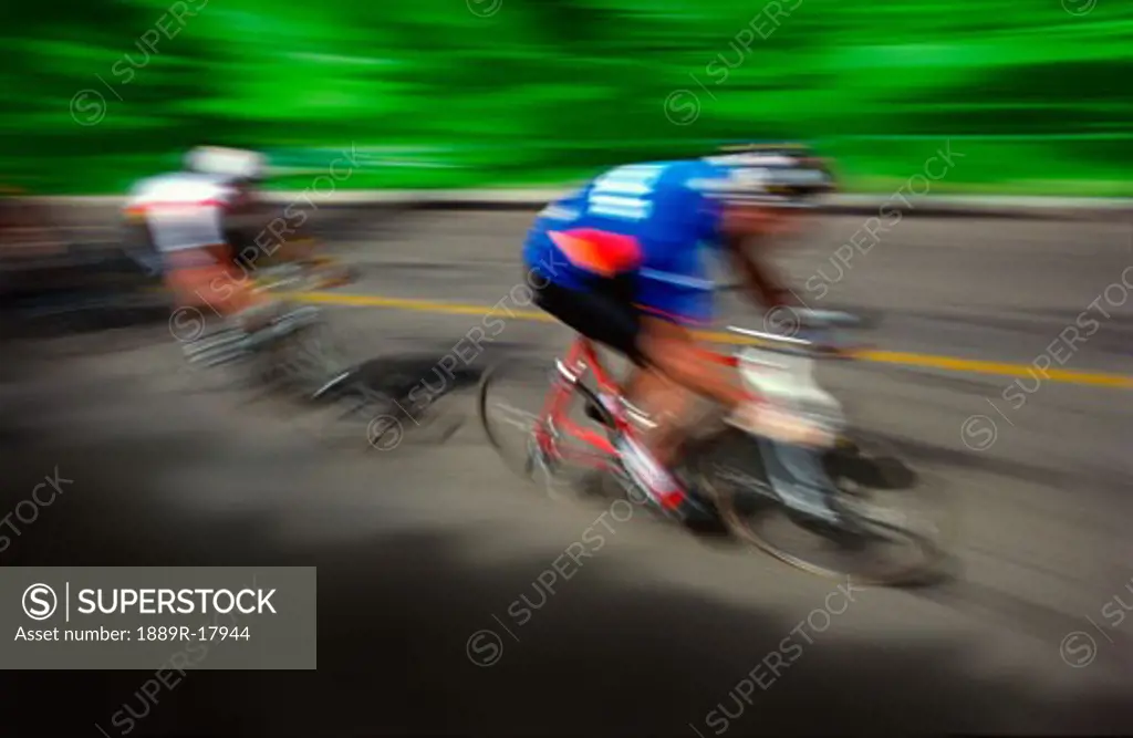 Two cyclists racing on road