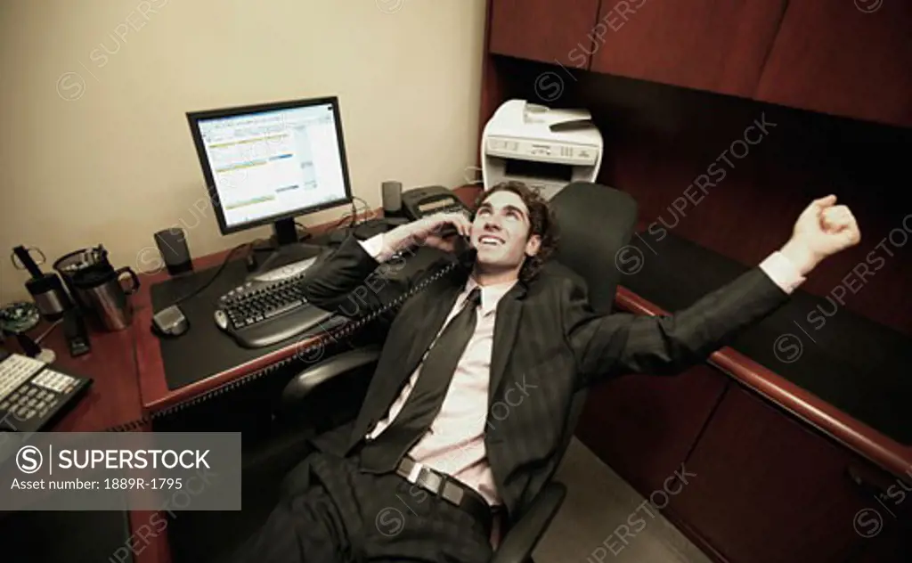 Business Man in office talking on phone