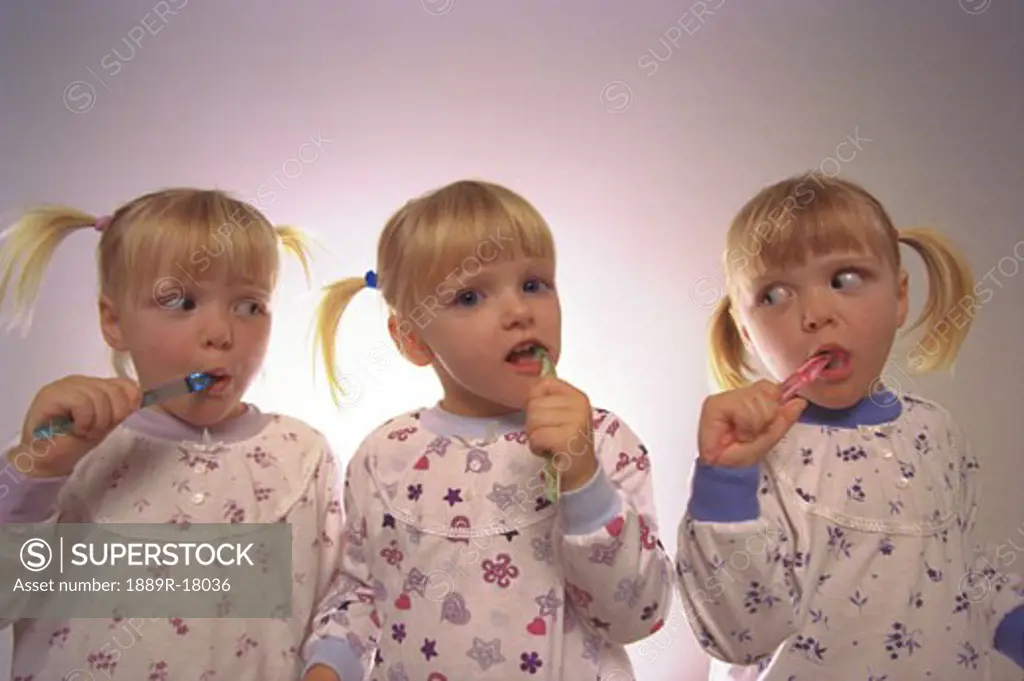 Triplets brushing teeth