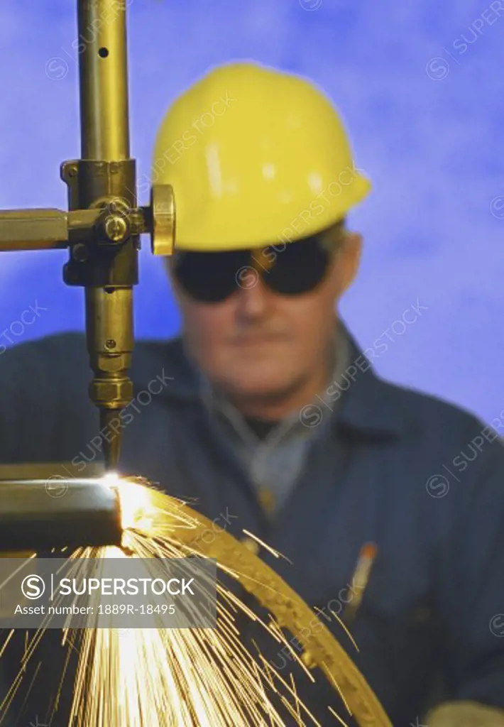 Construction worker monitoring steel cutter