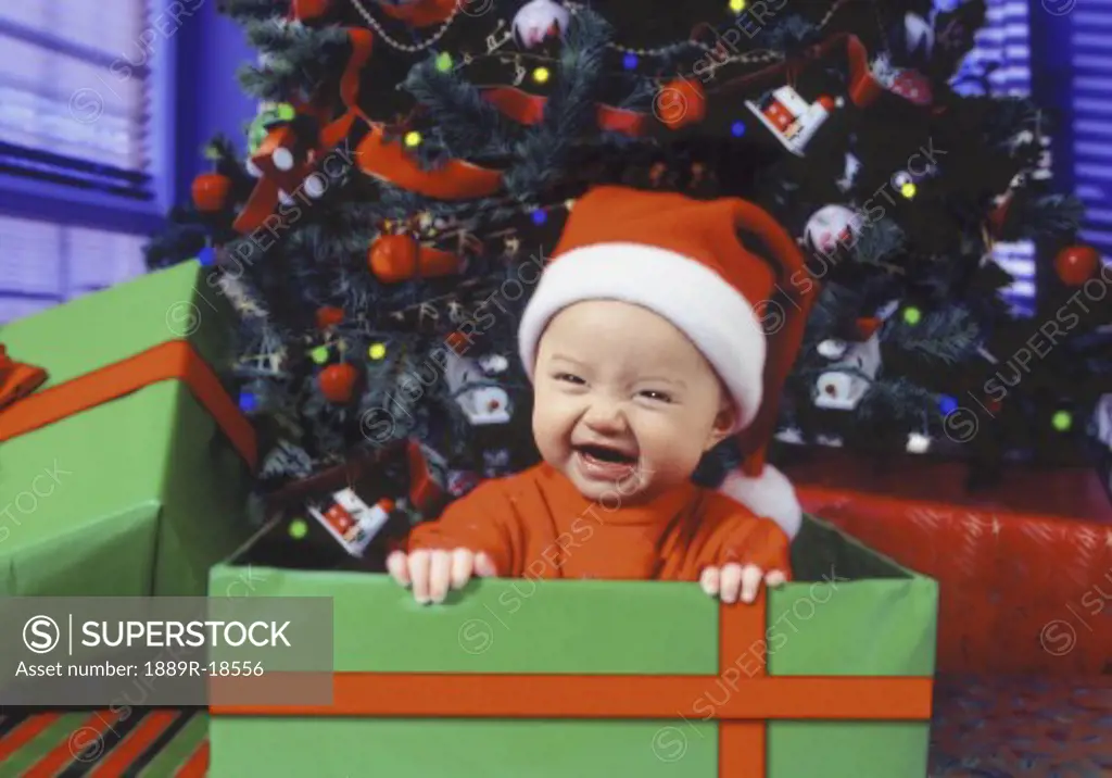Baby with santa hat in gift box