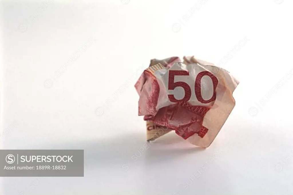 Crumpled fifty dollar bill