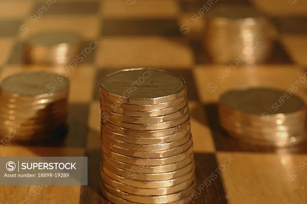 Piles of coins on checkerboard