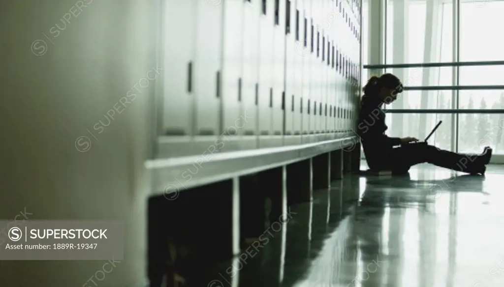 Student sitting by lockers