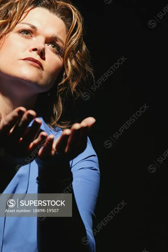 Woman surrendering to God