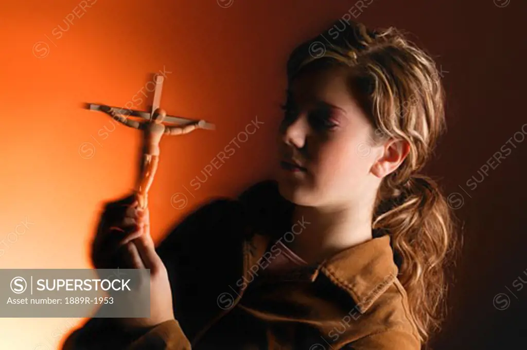 Young woman with symbol of Crucifixion