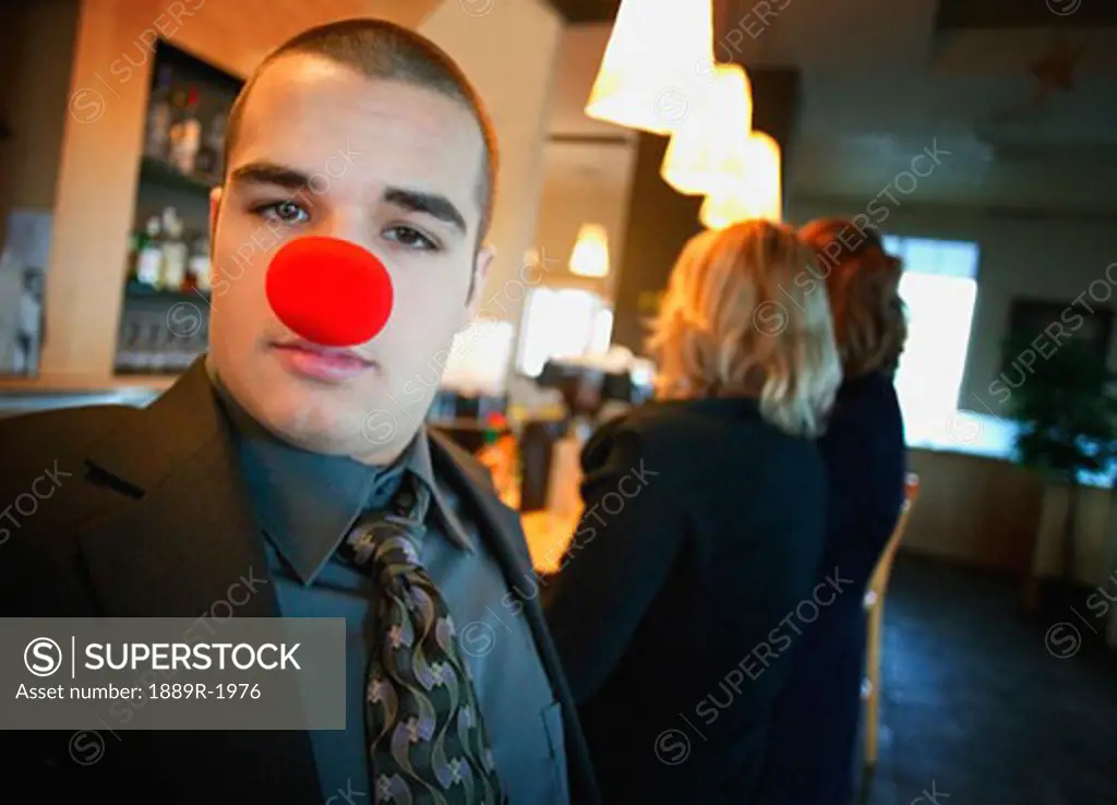 Businessman wearing red nose