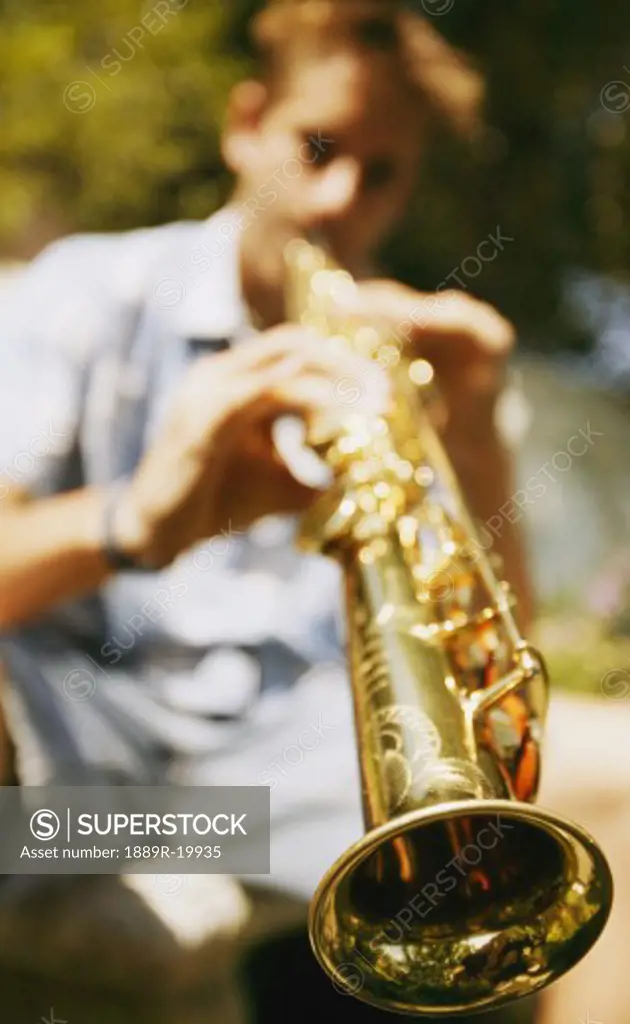 Young man plays soprano saxophone