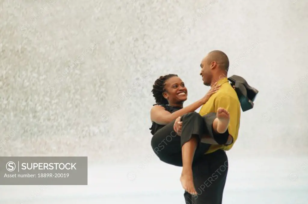 Couple together wading in pool