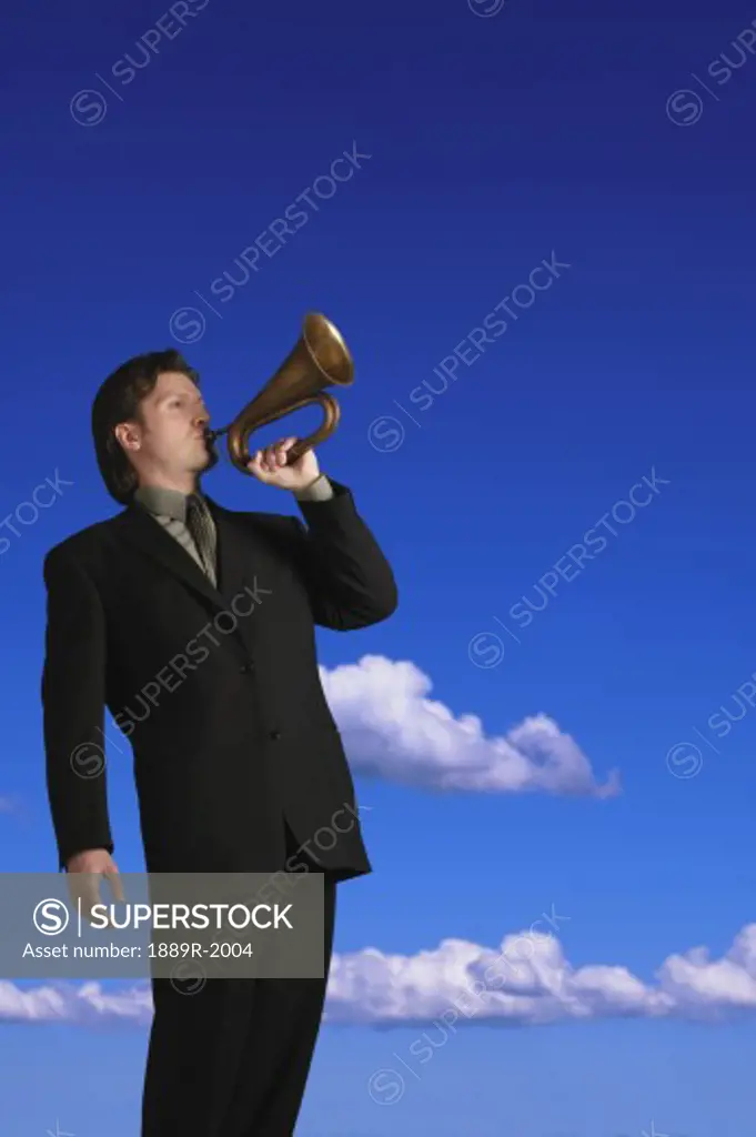 Man in suit blowing a bugle