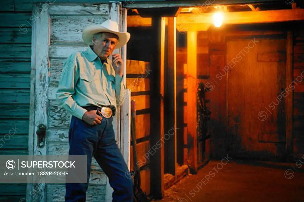 Cowboy stands by door