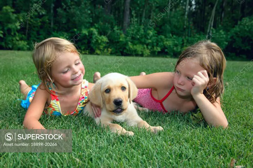 Children playing with puppy