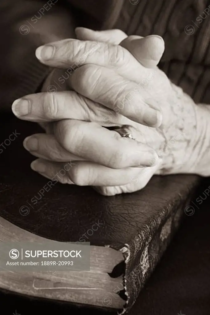 Senior praying with Bible