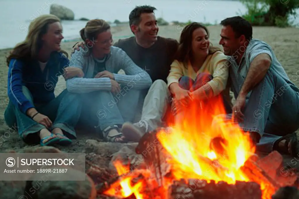 A group of people enjoy a bonfire