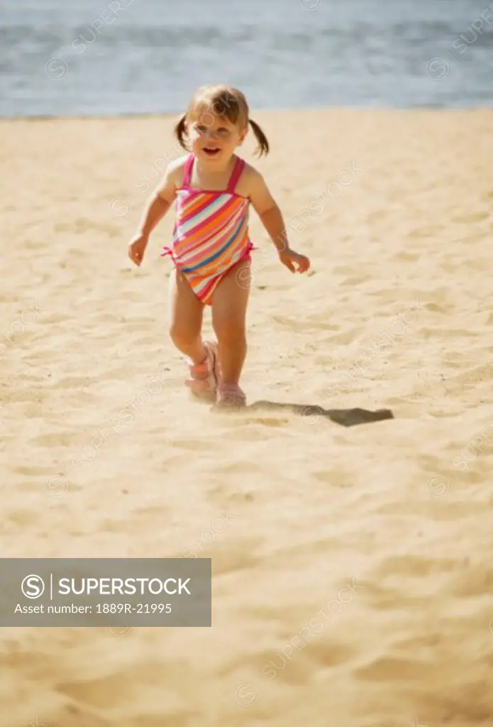 Child runs on the beach