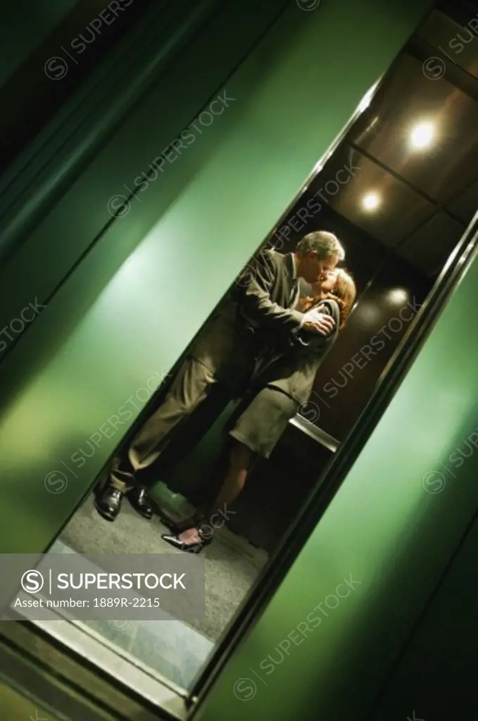 Couple kissing in elevator
