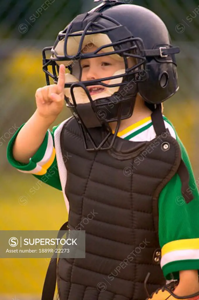 Portrait of boy's youth league baseball catcher