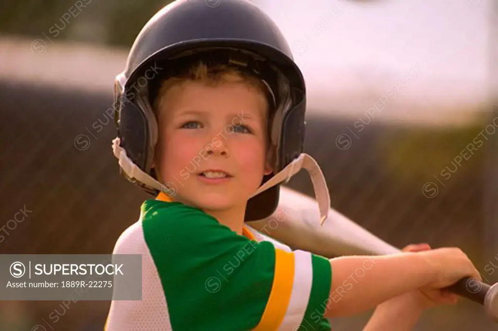 Portrait of little boy playing baseball
