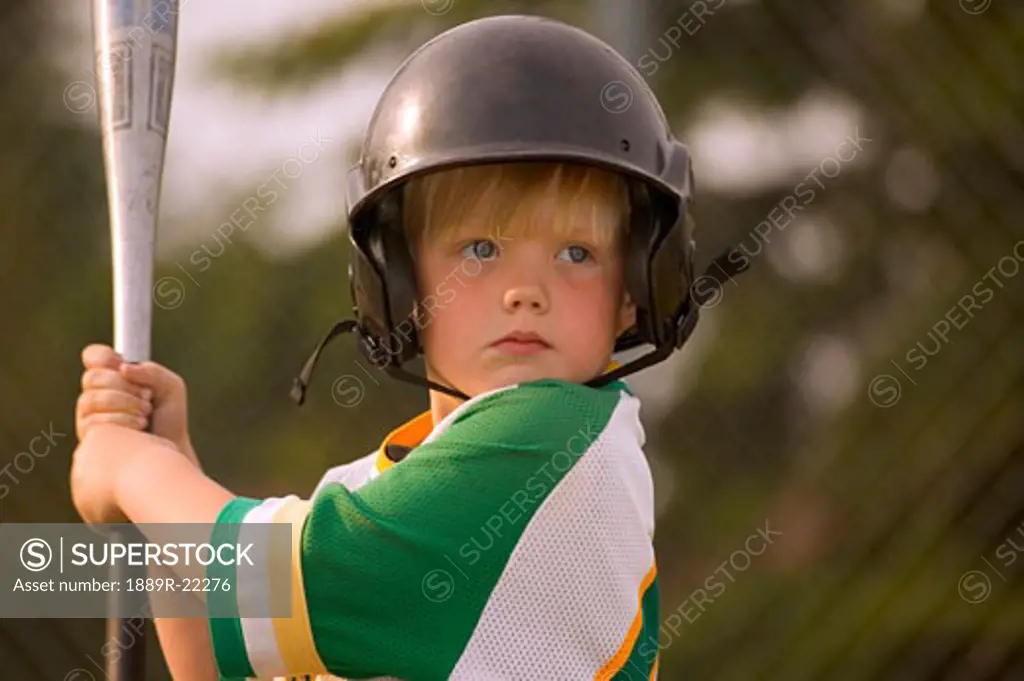 Portrait of small boy playing baseball