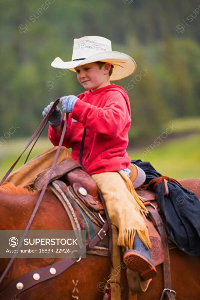 Young cowboy on horse