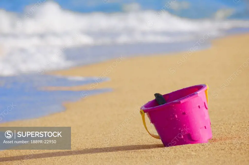 Beach bucket in sand