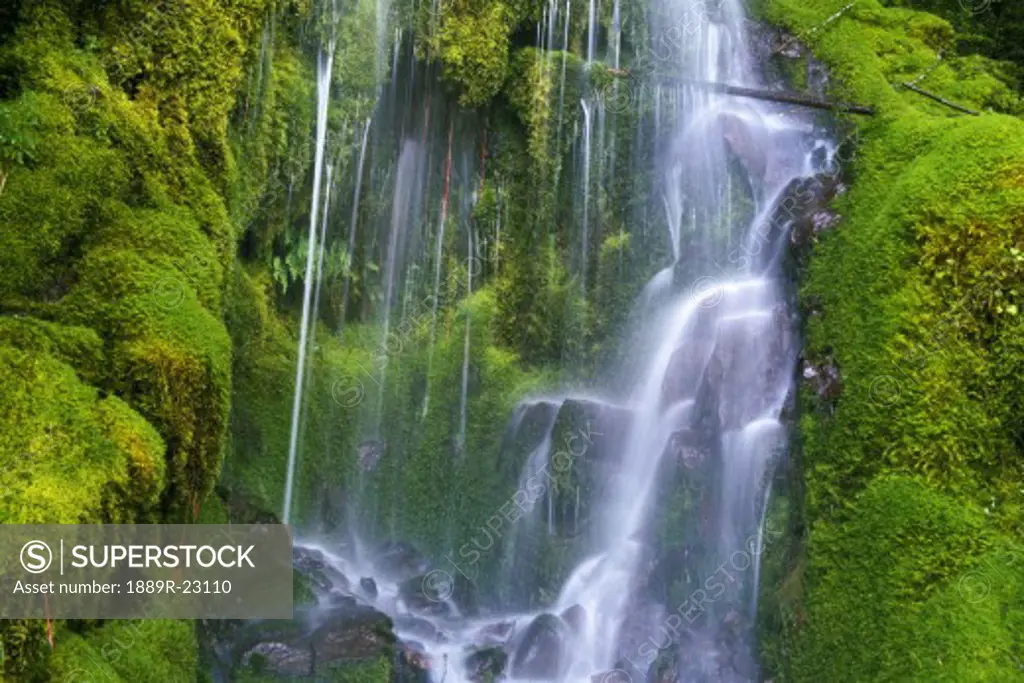 Waterfall over moss-covered rocks