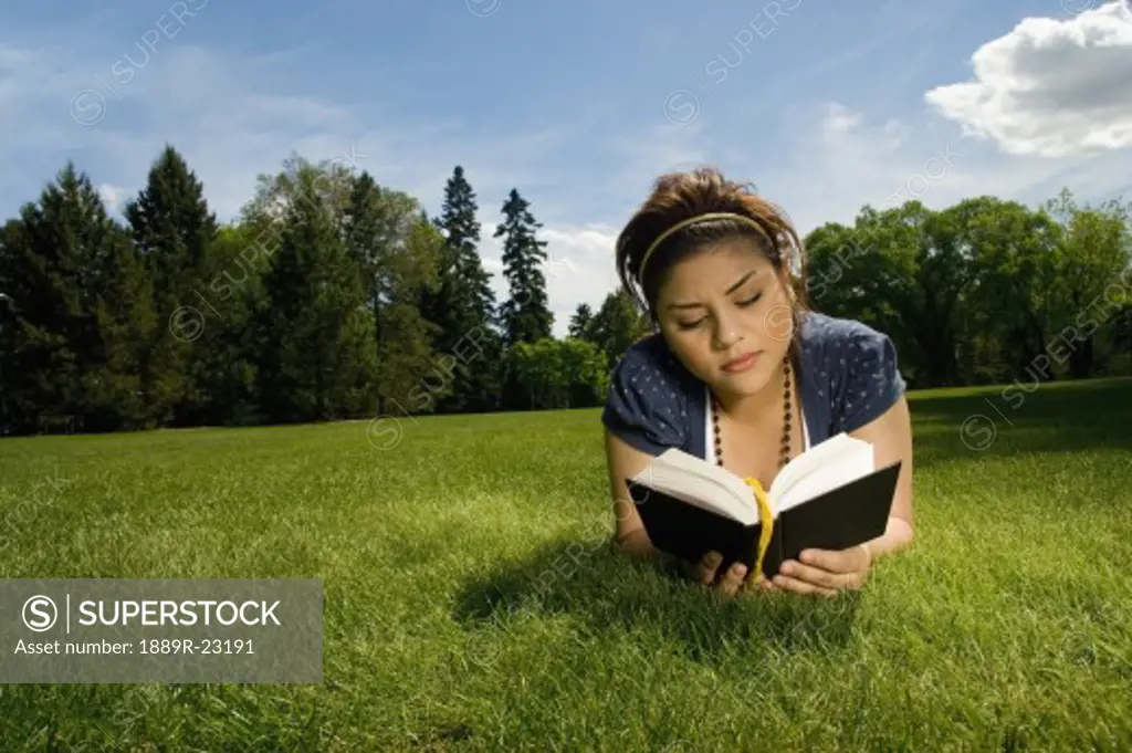 Portrait of young woman reading a book