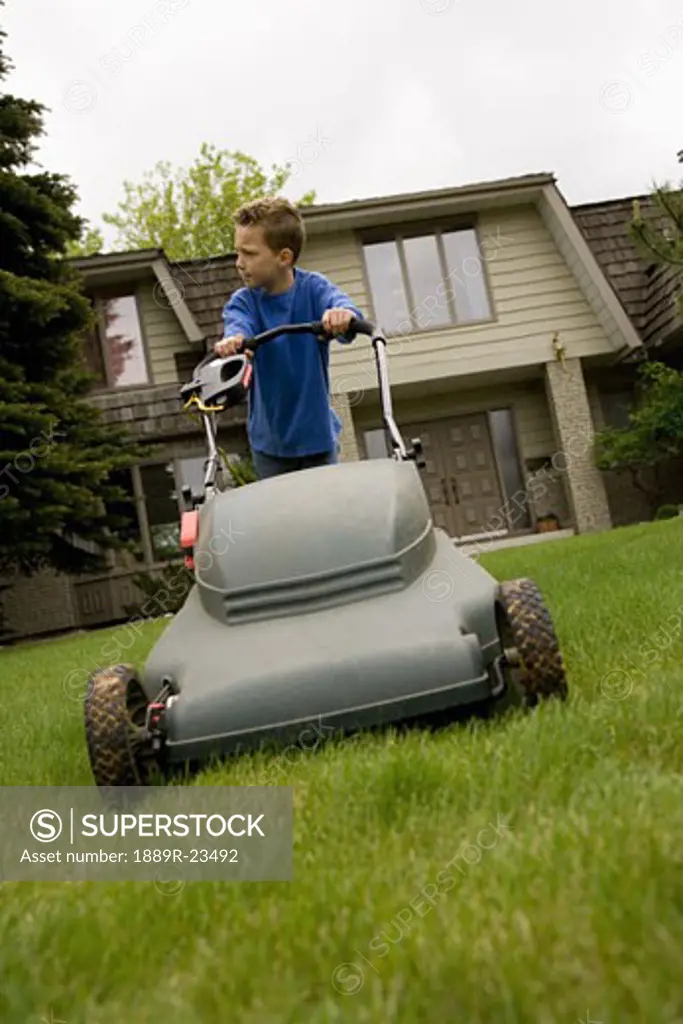 Young boy Mowing Lawn
