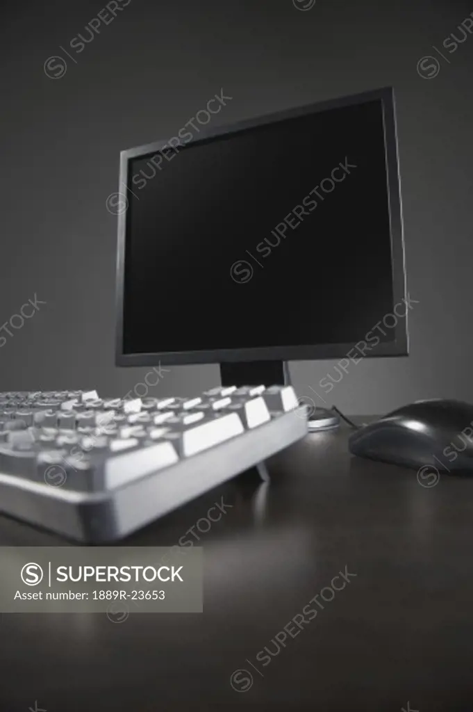Flatscreen computer monitor with keyboard and mouse