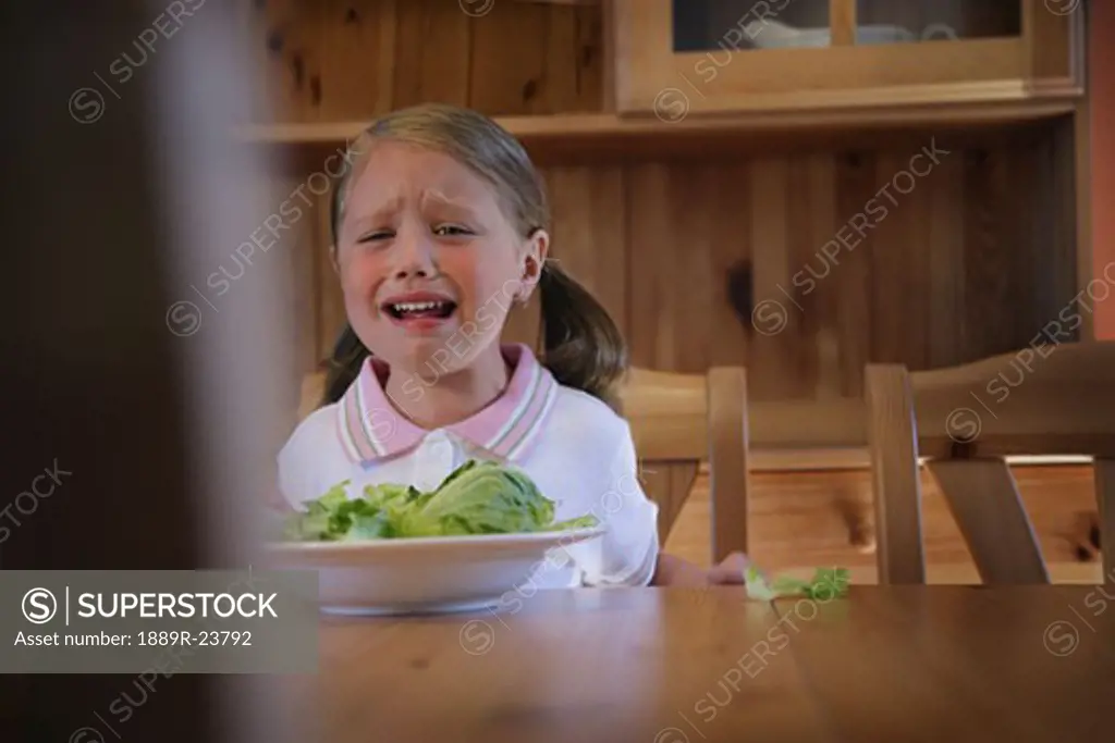 Girl crying over dinner