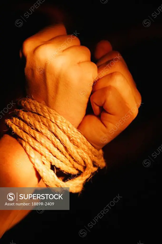 Wrists bound by rope