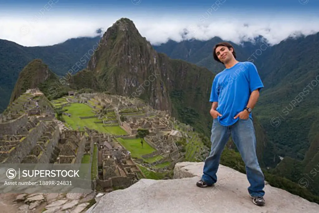 A man at the ancient Inca ruins of Machu Picchu, Peru
